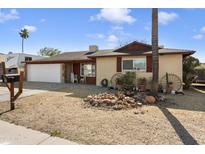 Ranch style home with a two-car garage and well-maintained landscaping at 4641 W Palo Verde Ave, Glendale, AZ 85302