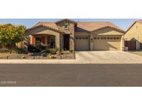 Single-story home with stone accents, two-car garage, and desert landscaping at 5508 N 190Th Dr, Litchfield Park, AZ 85340