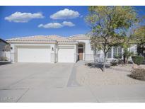 White single story home with a three car garage and desert landscaping at 7278 W Via Montoya Dr, Glendale, AZ 85310