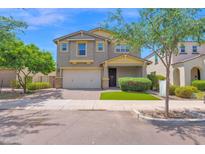 Charming two-story home with a well-manicured lawn and attached two-car garage at 9839 E Theia Dr, Mesa, AZ 85212