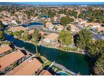 Aerial view of a house near a lake with a community of similar homes at 1610 W Maplewood St, Chandler, AZ 85286