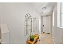 Bright entryway with wood bench and decorative wall accents at 1693 E Dogwood Ln, Gilbert, AZ 85295