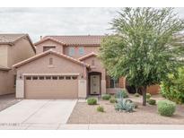 Two-story house with tan exterior, landscaped yard, and a two-car garage at 26133 W Yukon Dr, Buckeye, AZ 85396