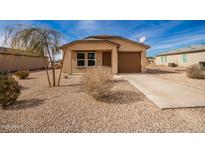 New construction home with desert landscaping and a brown garage door at 32014 N Redding St, Wittmann, AZ 85361