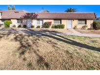 Front view of charming condo with brown tile roof and landscaped lawn at 3334 S Elm St, Tempe, AZ 85282