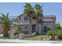 Two-story house with landscaped yard and palm trees at 3469 E Cabazon Ct, Gilbert, AZ 85297