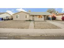 Tan single story house with front yard and driveway at 4216 N 72Nd Ln, Phoenix, AZ 85033