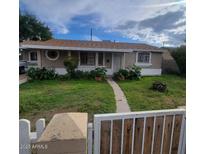 Ranch style home with a well-manicured lawn and gated entry at 4339 W Crittenden Ln, Phoenix, AZ 85031