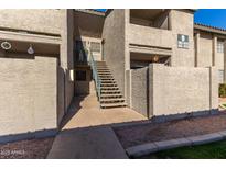 Exterior view of condo building with stairs leading to entrance at 533 W Guadalupe Rd # 1069, Mesa, AZ 85210