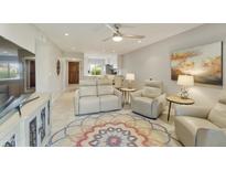 Bright living room with comfy seating and view to kitchen at 7732 E Desert Flower Ave, Mesa, AZ 85208