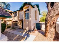 Front view of a two-story townhome with mature trees at 8039 N 48Th Ave, Glendale, AZ 85302