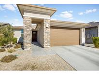 Single-story home with stone accents and two-car garage at 8908 W Bethany Heights Dr, Glendale, AZ 85305