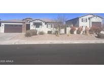 Single-story home with a two-car garage and desert landscaping at 9144 W Sands Dr, Peoria, AZ 85383