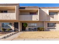 Tan two-story townhome with small front yard and walkway at 944 S Valencia -- # 3, Mesa, AZ 85202