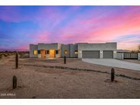 Stunning desert contemporary home with three-car garage and landscaped front yard at 12093 W Blackhawk Rd, Casa Grande, AZ 85194