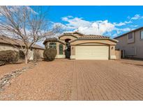 One-story home with a brick driveway and desert landscaping at 1358 E Jardin Dr, Casa Grande, AZ 85122