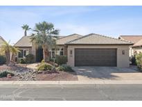 Single-story home with a dark brown garage door and landscaped front yard at 15045 W Mulberry Dr, Goodyear, AZ 85395