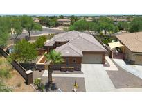 An aerial view of a house, showcasing its exterior, driveway, landscaping, and surrounding neighborhood at 15338 W Montecito Ave, Goodyear, AZ 85395