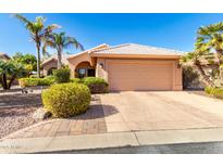 Single-story home with a two-car garage and landscaped front yard at 24502 S Starcrest Dr, Sun Lakes, AZ 85248