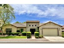 Single-story home with tile roof, stone accents, and a two-car garage at 3111 E Red Oak Ct, Gilbert, AZ 85297