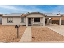 Charming home featuring a low-maintenance landscape, covered parking, and solar panels for energy efficiency at 335 S Stardust Ln, Apache Junction, AZ 85120