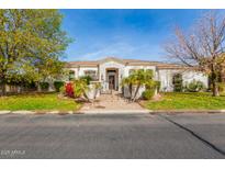 House exterior with stone accents, landscaping, and a large front yard at 3412 E Indigo Cir, Mesa, AZ 85213