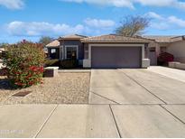 Single-story house with attached garage and desert landscaping at 4225 N 92Nd Ln, Phoenix, AZ 85037