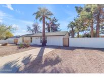 Charming home featuring a well-manicured front yard, a private fence and an attached two-car garage at 4311 E Bluefield Ave, Phoenix, AZ 85032