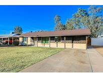 House exterior featuring a brown roof and a spacious lawn at 6016 N 36Th Dr, Phoenix, AZ 85019