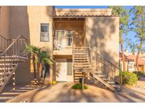 Exterior view of condo building with stairs and landscaping at 8787 E Mountain View Rd # 2101, Scottsdale, AZ 85258