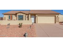 One-story home with a two-car garage and desert landscaping at 10334 W Sunbird Dr, Arizona City, AZ 85123