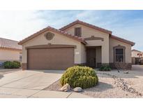 One-story house with brown garage door and landscaping at 11261 E Quarry Ave, Mesa, AZ 85212