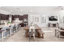 Eat-in kitchen with dark cabinetry and stainless steel appliances at 12064 S 186Th Ave, Goodyear, AZ 85338