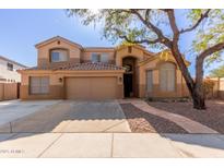 Two-story house with a large three-car garage and landscaped front yard at 16205 S 7Th St, Phoenix, AZ 85048