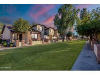 Brick townhouses with grassy area and walkway at 170 E Guadalupe Rd # 174, Gilbert, AZ 85234