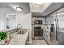 Modern kitchen with stainless steel appliances and granite countertops at 1720 E Thunderbird Rd # 2010, Phoenix, AZ 85022