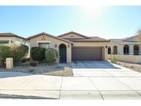 Single-story home with brown garage door and landscaped front yard at 17563 W Fairview St, Goodyear, AZ 85338