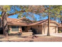 Tan two-story house with a tile roof, fountain, and two-car garage at 19633 N Marble Dr, Sun City West, AZ 85375