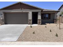 Charming single-story home with desert landscaping, a two-car garage, and a welcoming front porch at 20612 N 226Th Dr, Surprise, AZ 85387
