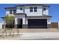 Two-story stucco home with a black garage door and stone accents at 2316 W Moody Trl, Phoenix, AZ 85041