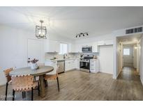 Bright kitchen features white shaker cabinets, stainless steel appliances, and wood-look tile floors at 3021 W Ocotillo Rd, Phoenix, AZ 85017