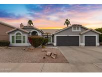 Two-story house with gray exterior, two-car garage, and landscaped yard at 810 S Lagoon Dr, Gilbert, AZ 85233