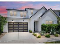 Two-story home with modern facade, landscaped yard, and two-car garage at 10150 E Thistle Ave, Mesa, AZ 85212