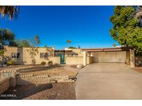 Single-story home with a large driveway and mature landscaping at 102 W El Caminito Dr, Phoenix, AZ 85021