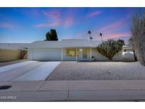 Cute single-story home with a two-car garage and desert landscaping at 10629 W Willow Creek Cir, Sun City, AZ 85373