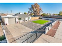 Property with artificial turf, block wall, and gated entry at 10902 W Flanagan St, Avondale, AZ 85323