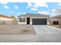 New single-story home with a two-car garage and desert landscaping at 11225 E Marigold Ln, Florence, AZ 85132