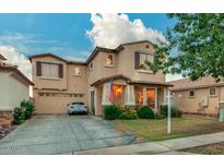 Two-story house with attached garage and landscaped front yard at 1806 E Ellis St, Phoenix, AZ 85042