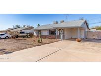 Charming single-story home featuring a rock facade and a covered carport at 1940 S Coconino Dr, Apache Junction, AZ 85120