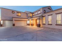 Two-story house with a three-car garage and landscaping at 306 E Dennisport Ct, Gilbert, AZ 85295